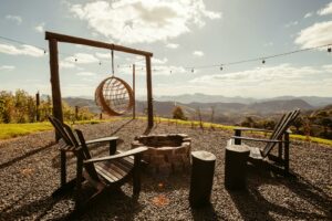 Experience serene outdoor glamping with a fire pit and mountain views in Santa Teresa, Brazil.